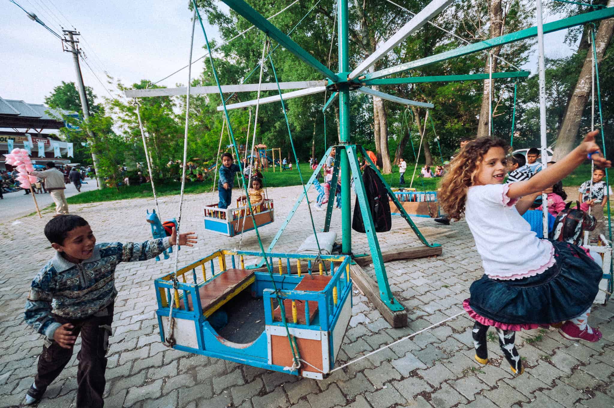 Documentary photograph of children on a fairground ride at the Kakava festival, Edirne, Turkey, 2009 by Tarık Kaan Muslu