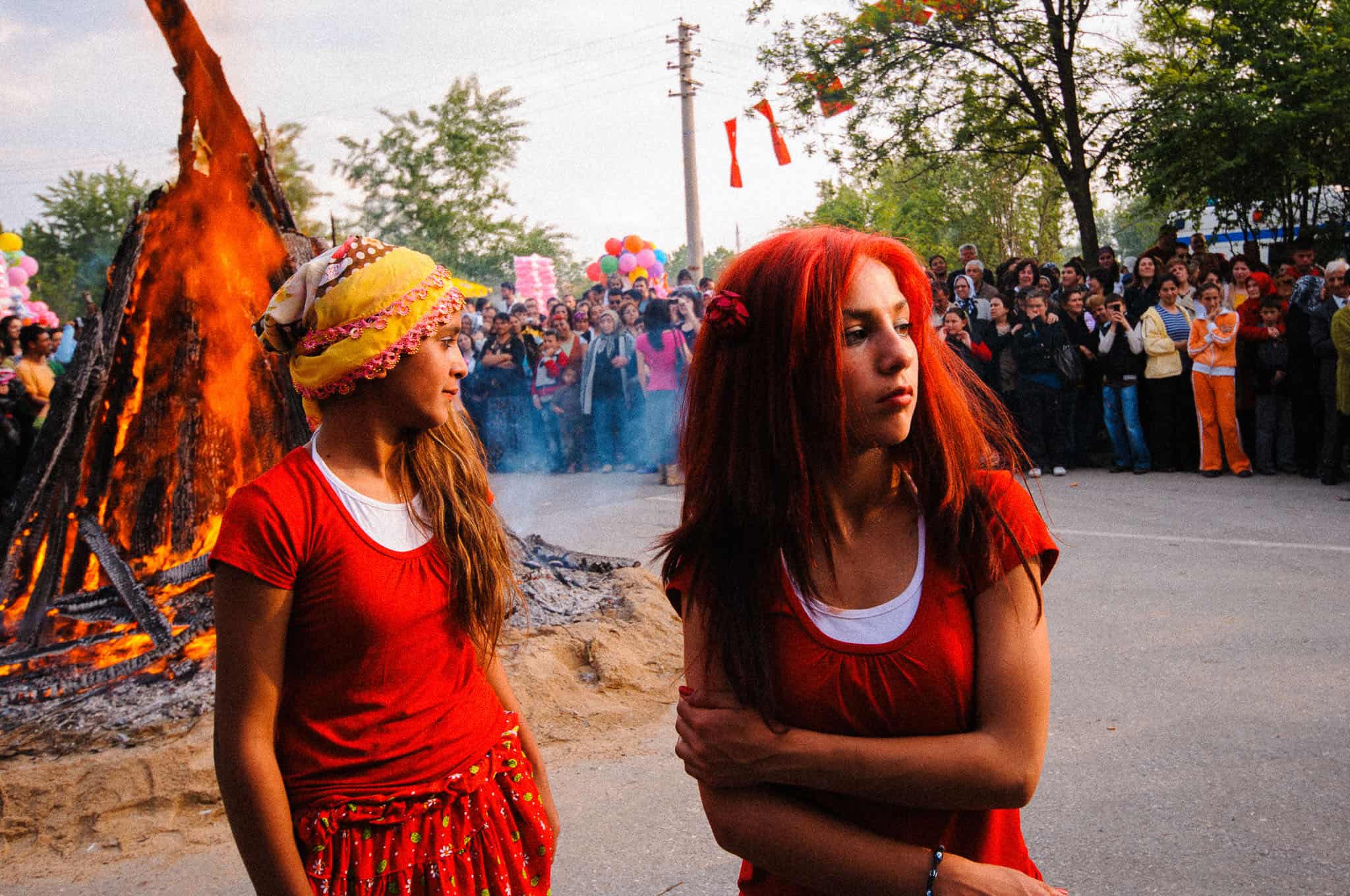 Documentary photograph of two young women by the bonfire at the Kakava Hıdırellez festival, Edirne, Turkey, 2009 by Tarık Kaan Muslu